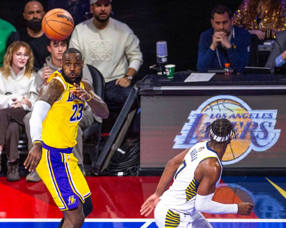 Los Angeles Lakers forward LeBron James (23) passes the ball as Indiana Pacers guard Buddy Hiel ...