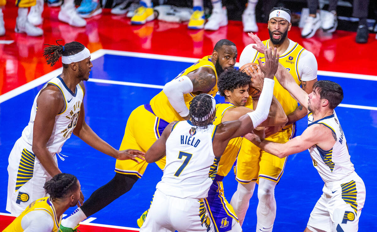 Los Angeles Lakers guard Max Christie (10) battles to keep the ball from Indiana Pacers guard B ...