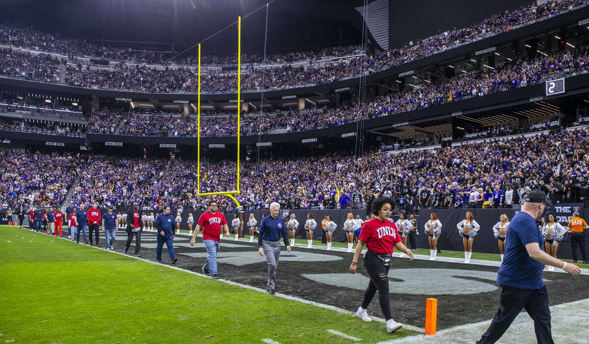 UNLV representatives participate in a moment of silence on the goal line before the start of th ...