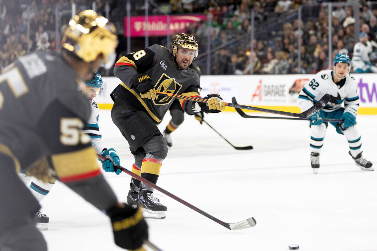 Vegas Golden Knights left wing William Carrier (28) passes the puck to right wing Keegan Kolesa ...