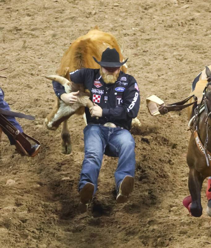 Will Lummus, of Byhalia, Miss., competes in steer wrestling during the first night of the Nati ...