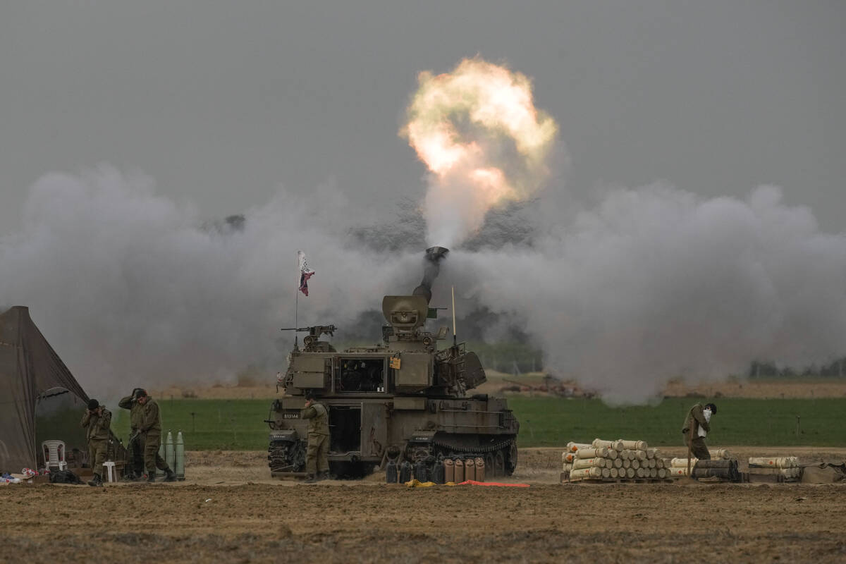 An Israeli mobile artillery unit fires a shell from southern Israel towards the Gaza Strip, in ...