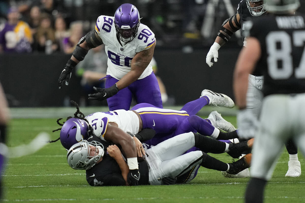 Las Vegas Raiders quarterback Aidan O'Connell is sacked by Minnesota Vikings linebacker Pat Jon ...