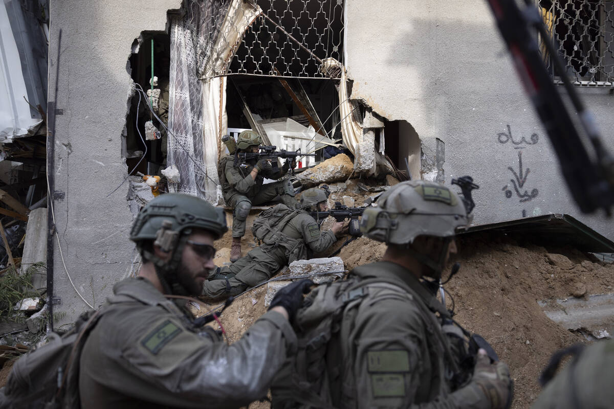 Israeli soldiers take part in a ground operation in Gaza City's Shijaiyah neighborhood, Friday, ...