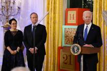 President Joe Biden speaks at a Hanukkah reception in the East Room of the White House in Washi ...