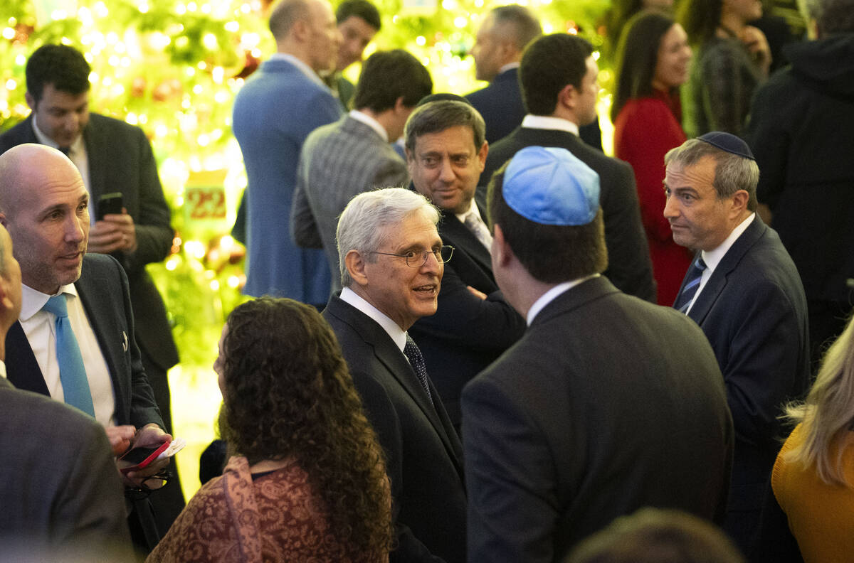 Attorney General Merrick Garland speaks to a guest at a Hanukkah reception with President Joe B ...