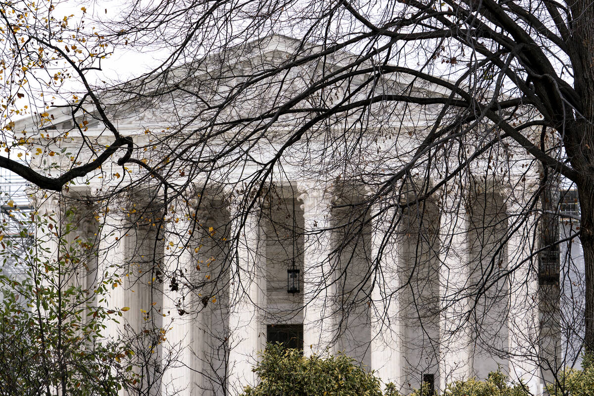 The Supreme Court is seen amid bare tree branches, on Capitol Hill in Washington, Dec. 7, 2023. ...