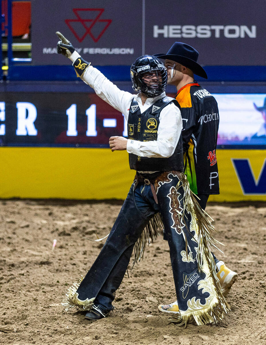 Sage Kimzey celebrates after taking first place in Bull Riding during day 5 action of the NFR a ...