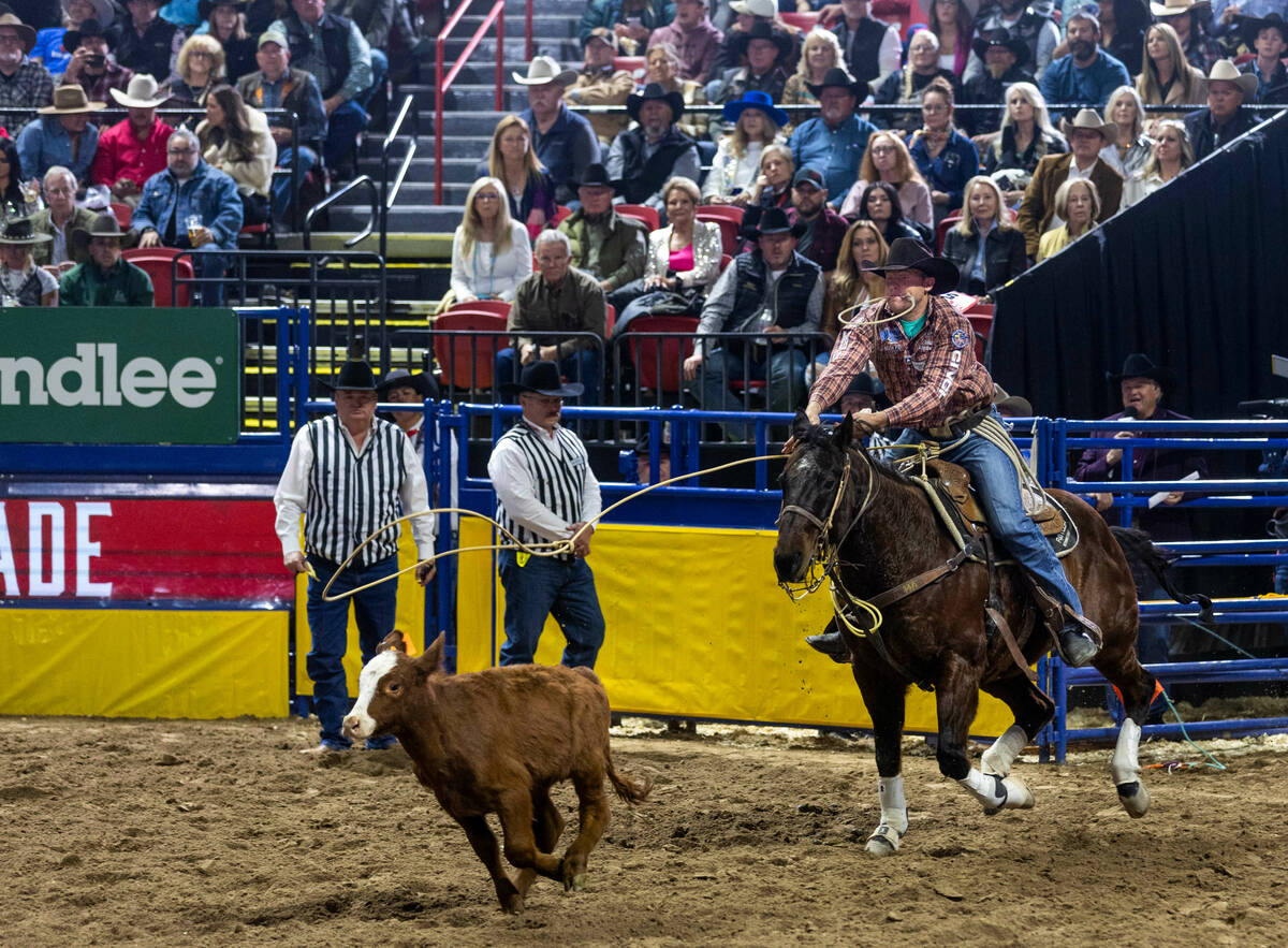Caleb Smidt takes first place in Tie-Down Roping during day 5 action of the NFR at the Thomas & ...