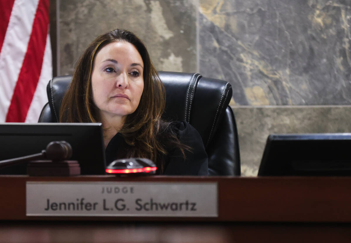 Judge Jennifer L.G. Schwartz listens as former Las Vegas police detective Lawrence Rinetti Jr. ...