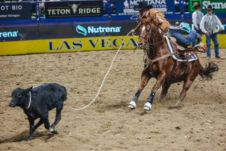 Blane Cox ropes the calf during tie down roping during day three of the National Finals Rodeo a ...