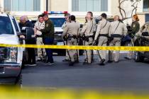 Las Vegas police investigate the scene of a shooting at a northwest valley apartment complex, M ...