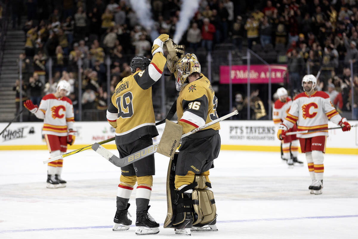 Golden Knights center Ivan Barbashev (49) and goaltender Logan Thompson (36) celebrate their ov ...