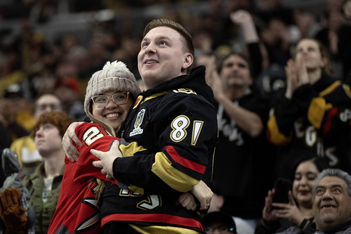 A couple embraces after the Golden Knights scored a goal during the third period of an NHL hock ...