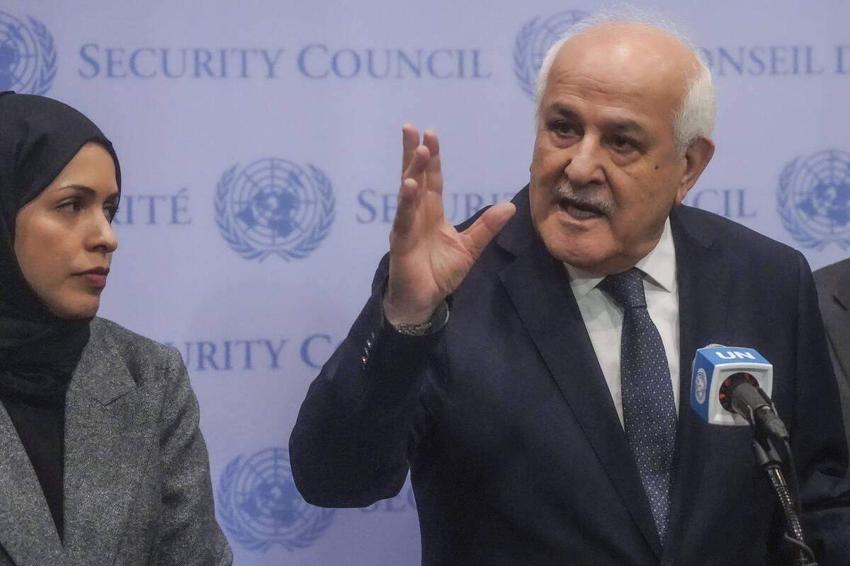 Palestinian United Nations Ambassador Riyad Mansour, right, speaks during a press conference ah ...