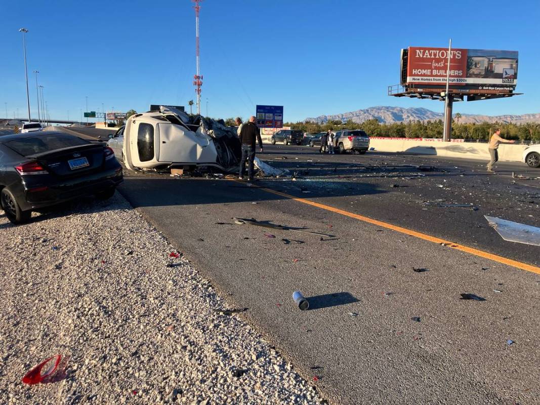 A vehicle is overturned near the scene of a crash that left three dead on U.S. Highway 95 near ...