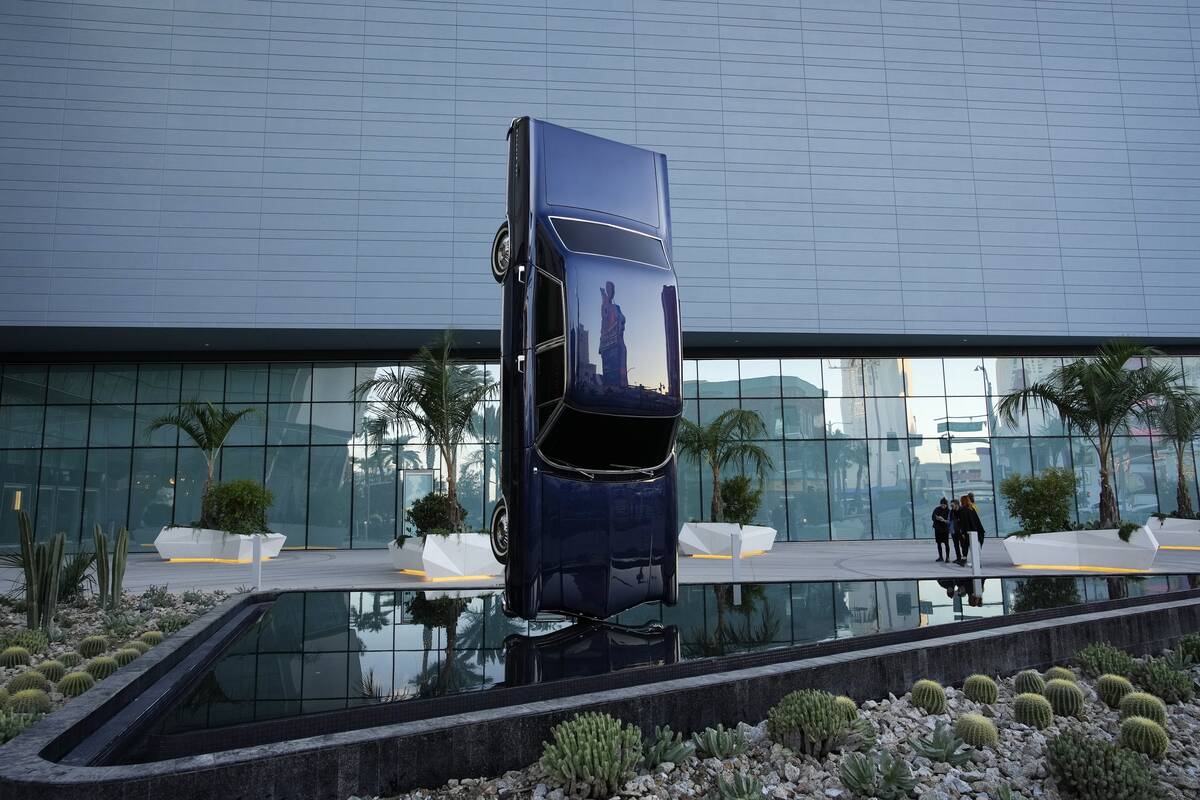 People stand beside the sculpture titled History of Suspended Time at an entrance to the Fontai ...