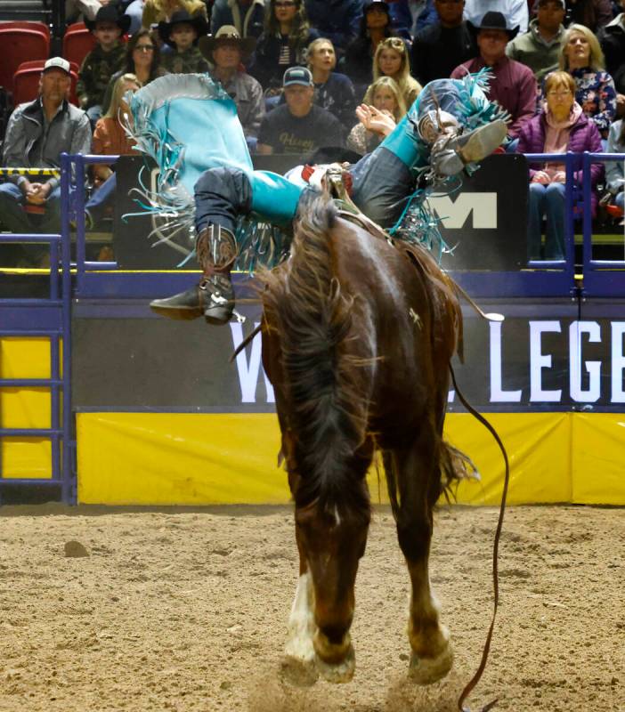 Jess Pope holds on to his horse while he competes in bareback riding on day six of the National ...