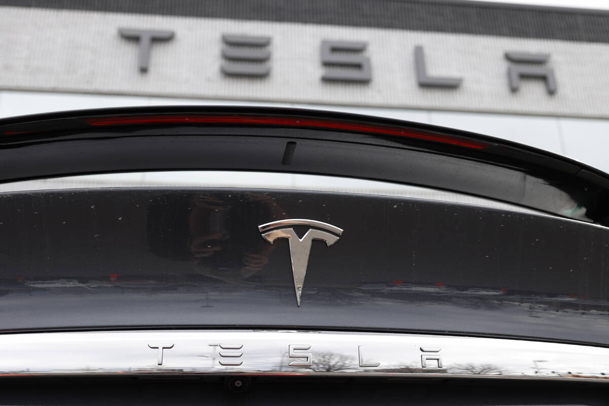FILE - The Tesla company logo shines off the rear deck of an unsold 2020 Model X at a Tesla dea ...