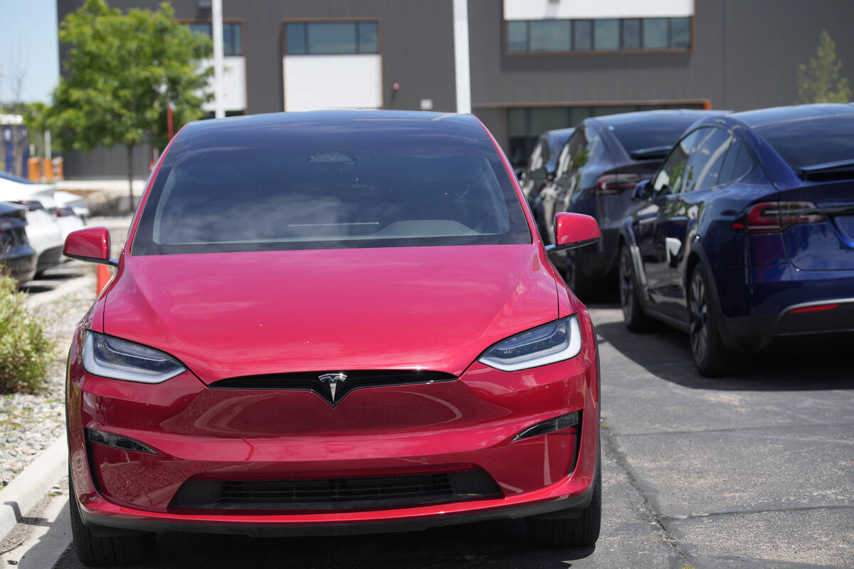 File - An unsold 2023 Model X sports-utility vehicle sits at a Tesla dealership June 18, 2023, ...