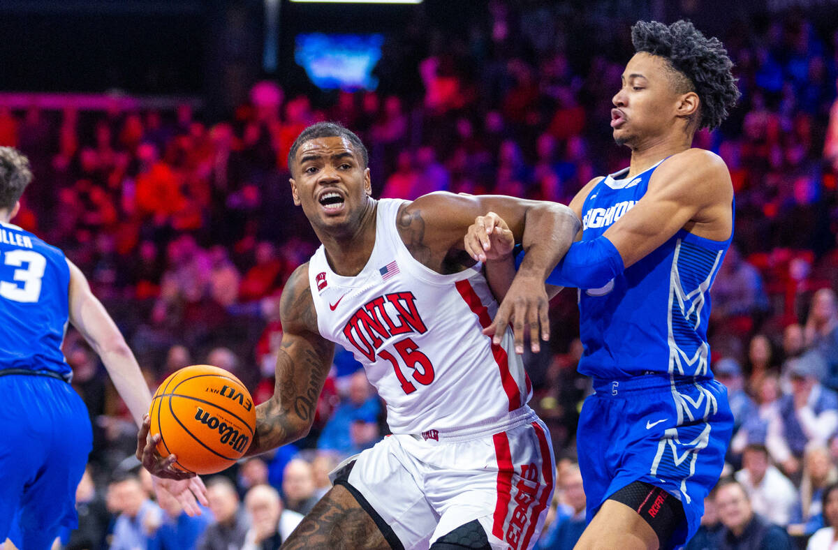 UNLV Rebels guard Luis Rodriguez (15) battles in the lane with Creighton Bluejays guard Trey Al ...