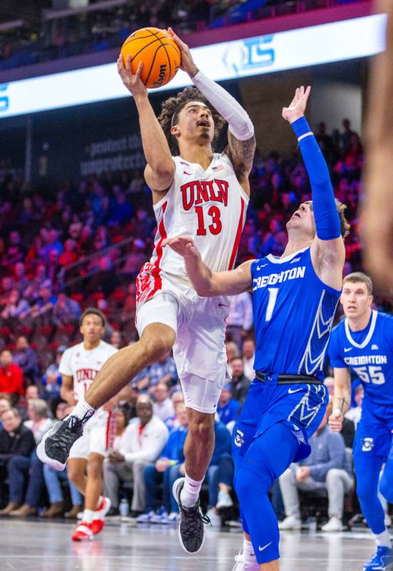 UNLV Rebels guard Brooklyn Hicks (13) posts up for a shot over Creighton Bluejays guard Steven ...