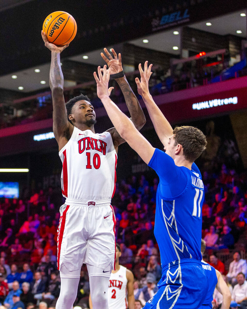 UNLV Rebels forward Kalib Boone (10) looks to shoot over Creighton Bluejays center Ryan Kalkbre ...