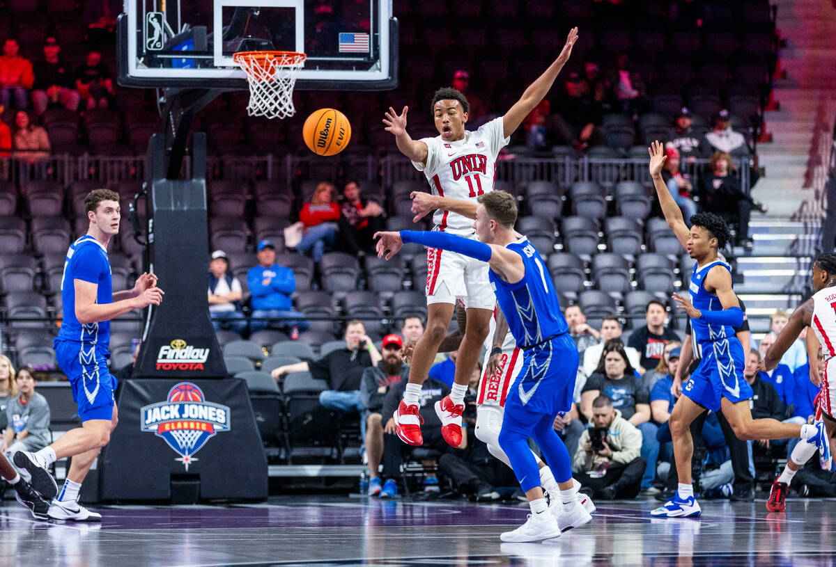 UNLV Rebels guard Dedan Thomas Jr. (11) leaps in the air to defend a pass by Creighton Bluejays ...