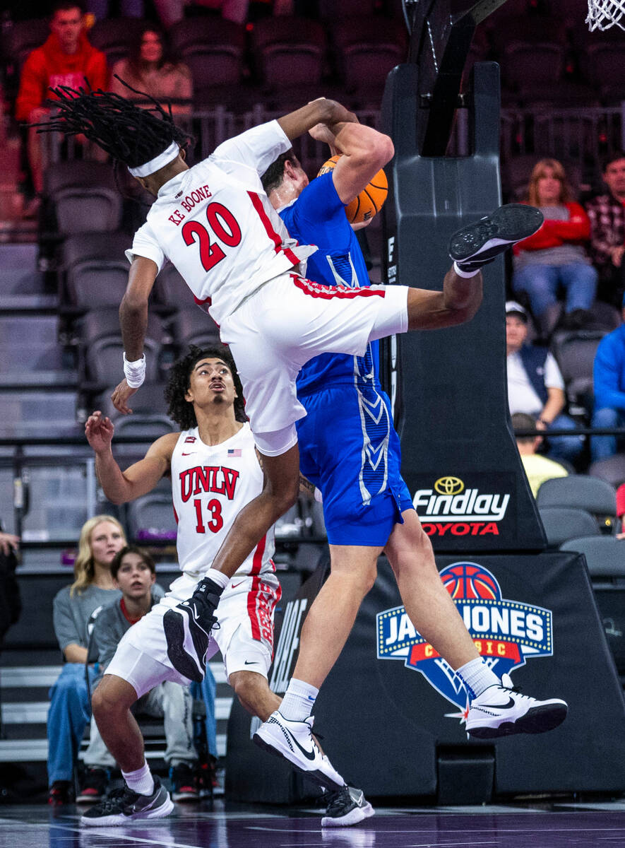 UNLV Rebels forward Keylan Boone (20) comes down atop of Creighton Bluejays center Ryan Kalkbre ...