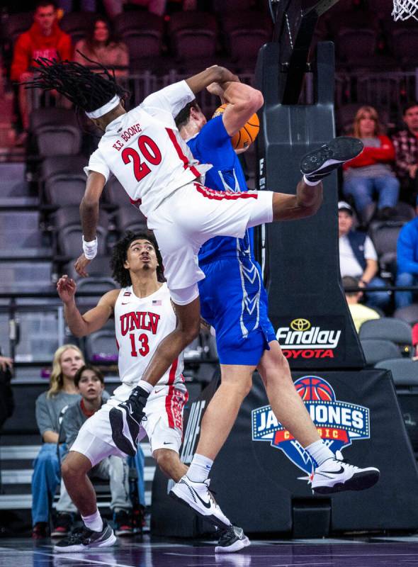 UNLV Rebels forward Keylan Boone (20) comes down atop of Creighton Bluejays center Ryan Kalkbre ...