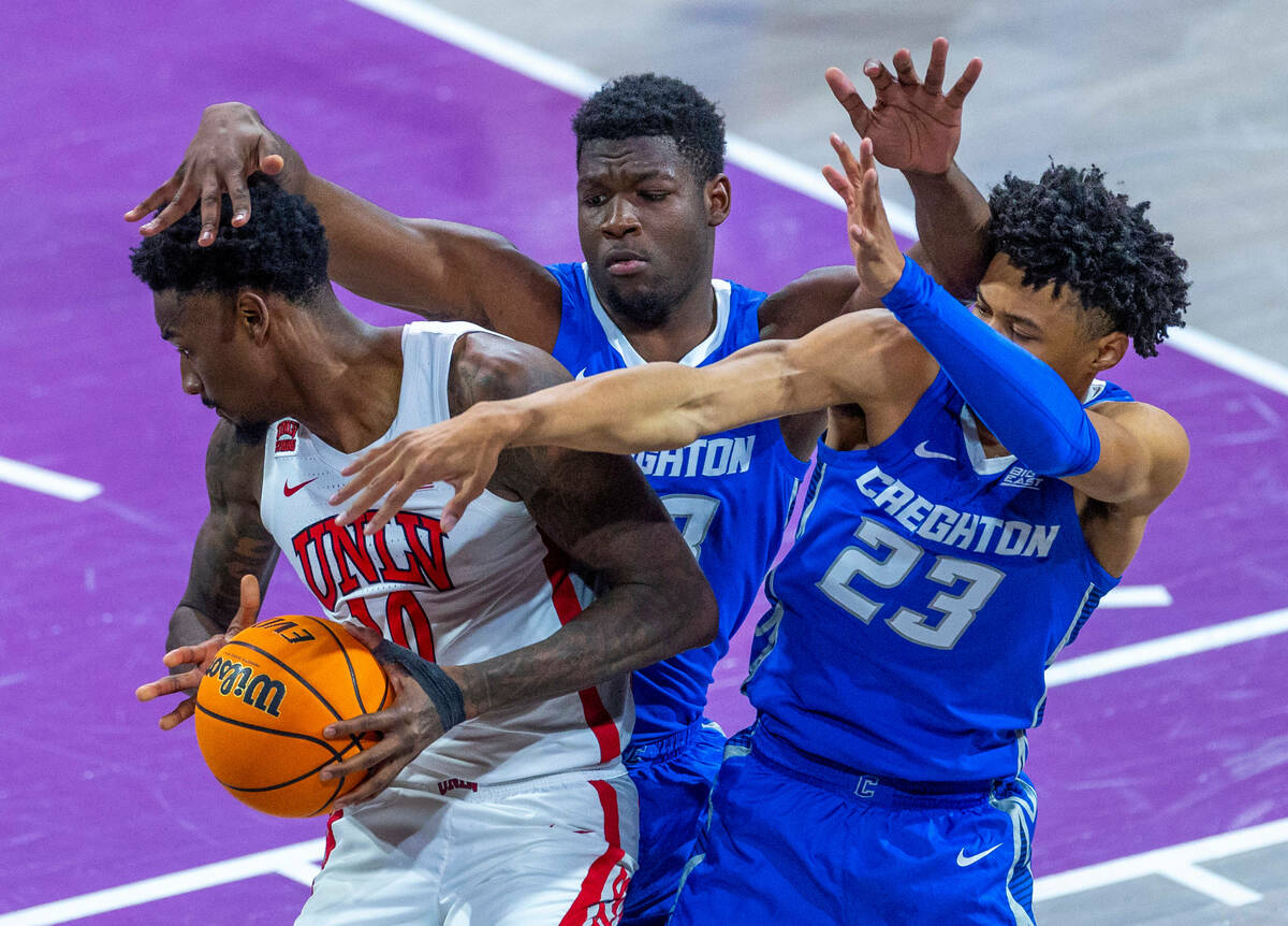 UNLV Rebels forward Kalib Boone (10) Creighton Bluejays center Fredrick King (33) and guard Tre ...