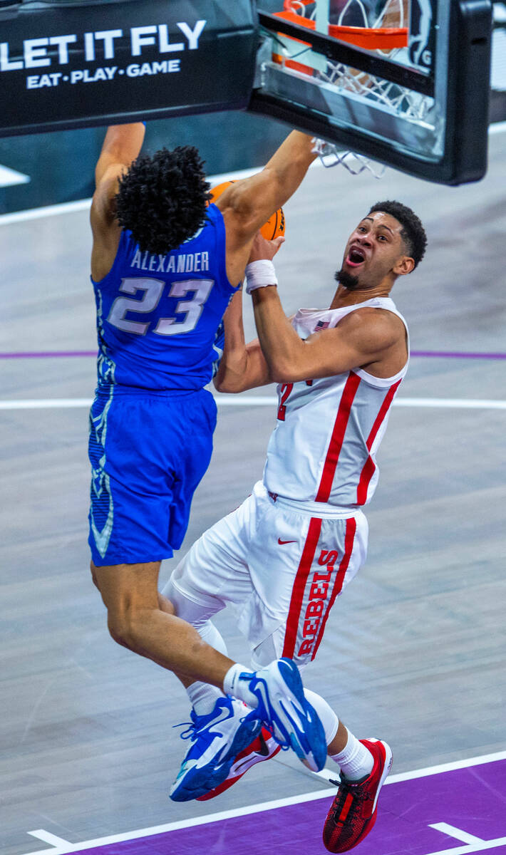 UNLV Rebels guard Justin Webster (2) eyes the basket as Creighton Bluejays guard Trey Alexander ...