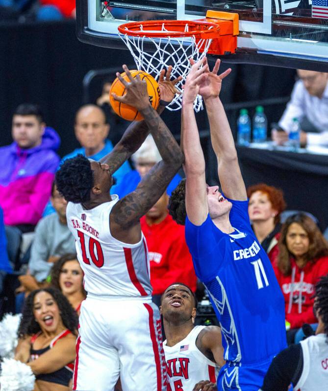 UNLV Rebels forward Kalib Boone (10) grabs a rebound over Creighton Bluejays center Ryan Kalkbr ...