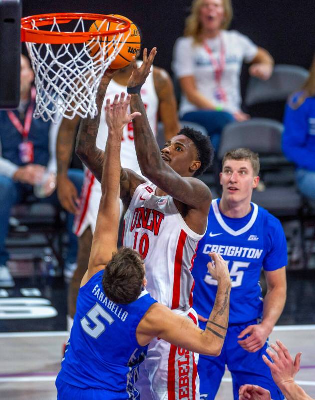 UNLV Rebels forward Kalib Boone (10) elevates above Creighton Bluejays guard Francisco Farabell ...