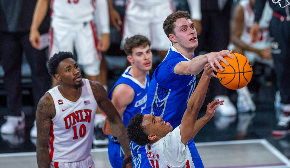 UNLV Rebels guard Dedan Thomas Jr. (11) has a ball stuffed by Creighton Bluejays center Ryan Ka ...