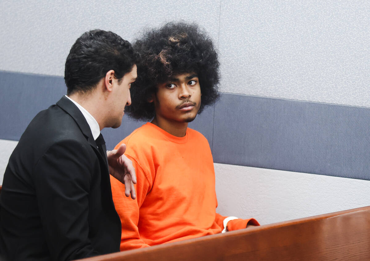 Defense attorney Daniel Martinez, left, speaks to his client Treavion Randolph, 16, right, one ...