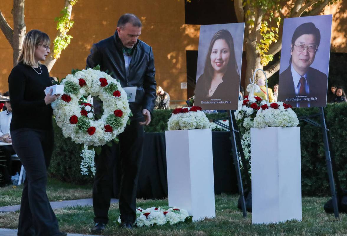 UNLV community members prepare to place a flower wreath in front of the picture of Dr. Jerry Ch ...