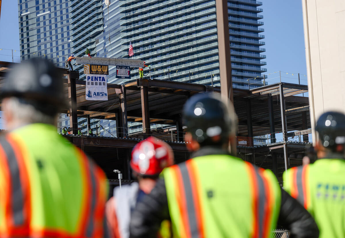 Workers watch the topping off ceremony for BLVD, a 400,000 square foot retail dining center on ...