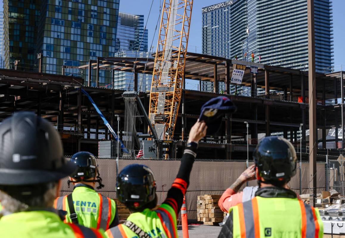 Workers watch the topping off ceremony for BLVD, a 400,000 square foot retail dining center on ...