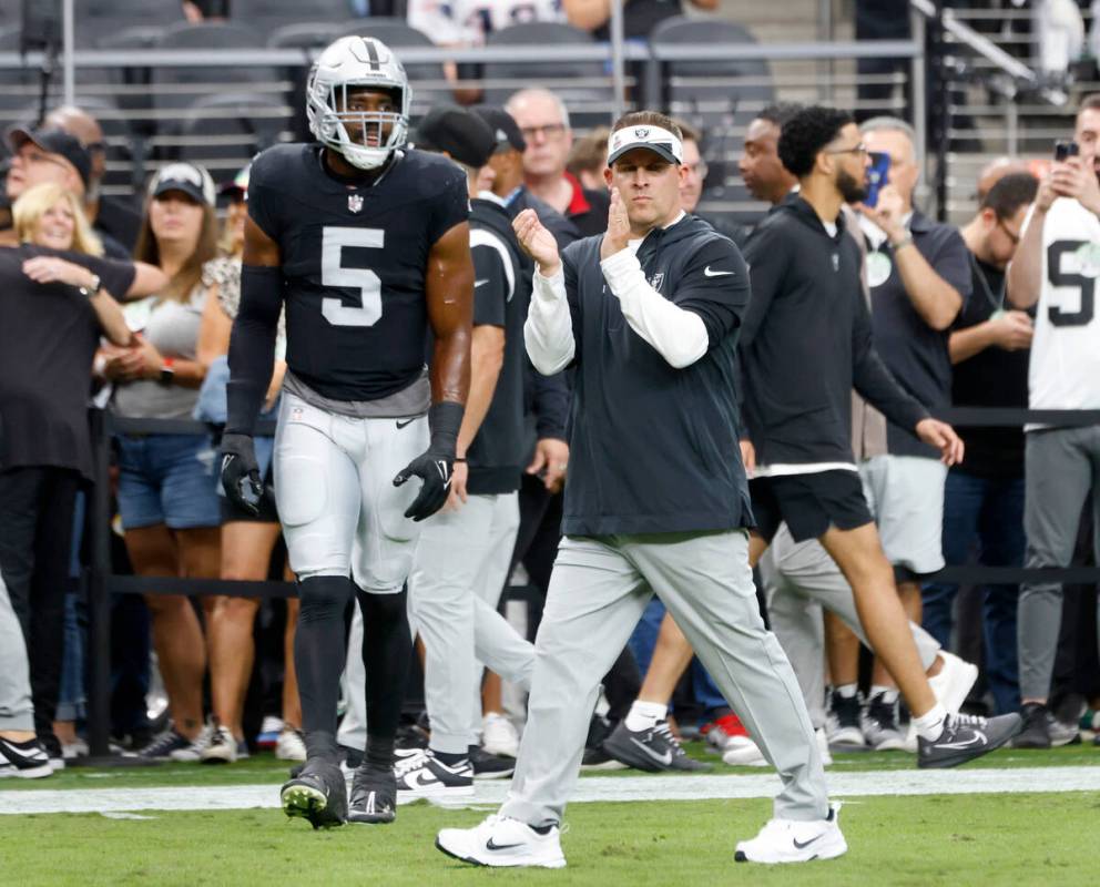 Raiders head coach Josh McDaniels reacts to a play during the first half of an NFL football gam ...