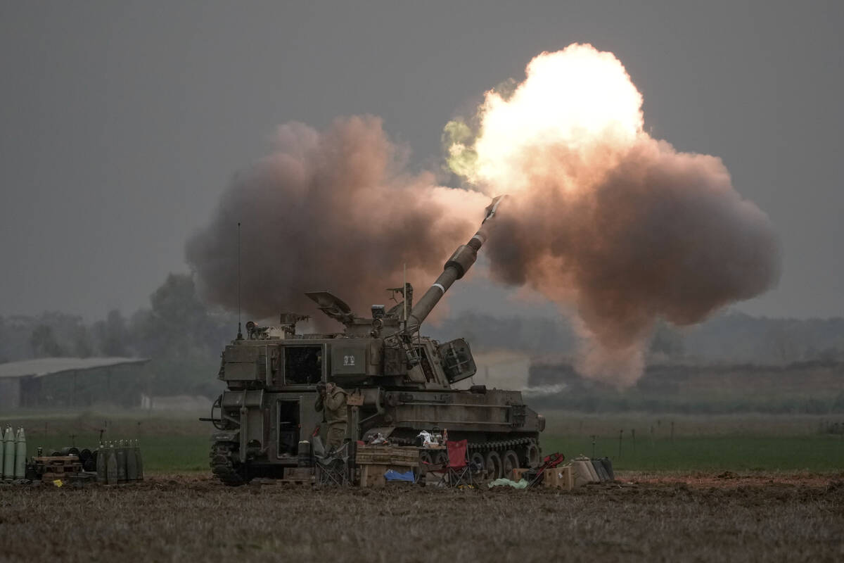 An Israeli mobile artillery unit fires a shell from southern Israel towards the Gaza Strip, in ...