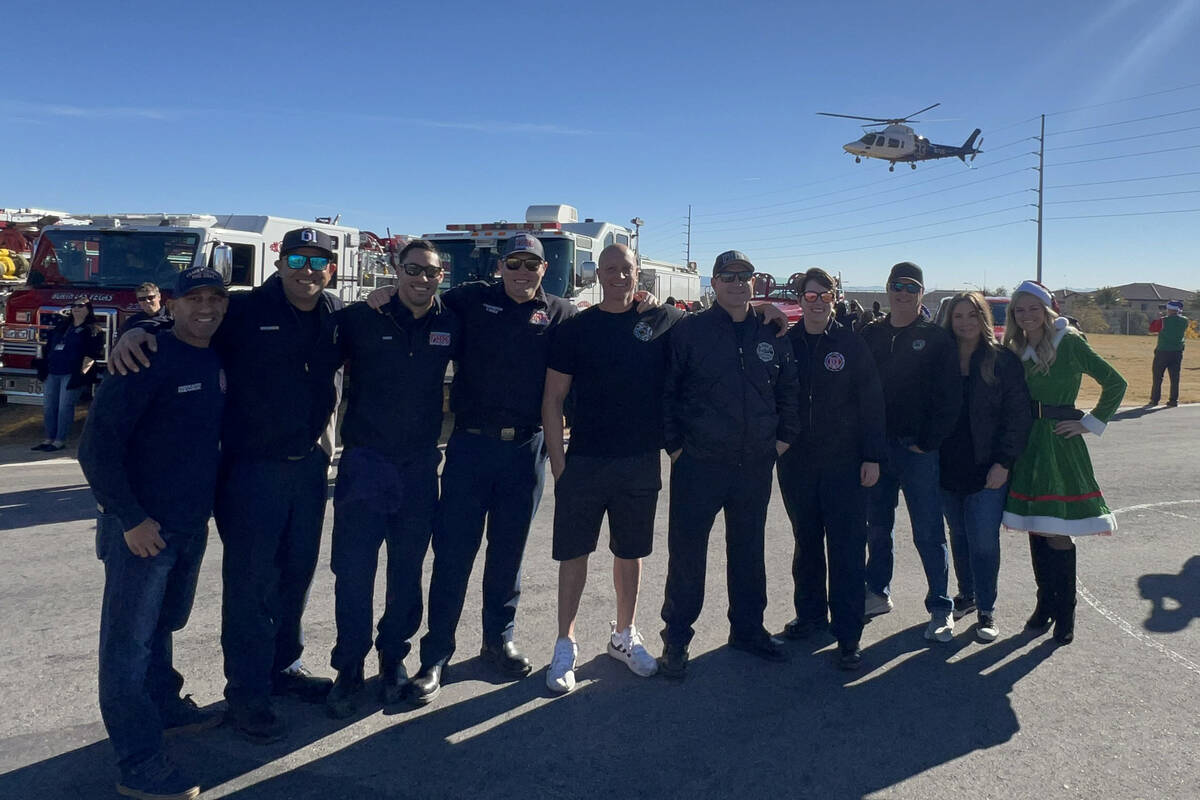 Firefighters from the Firefighters of Southern Nevada Burn Foundation distribute toys to studen ...