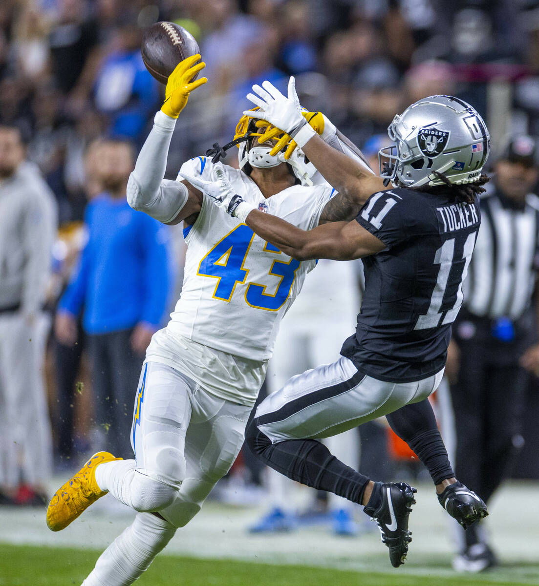 Los Angeles Chargers cornerback Michael Davis (43) and Raiders wide receiver Tre Tucker (11) ba ...