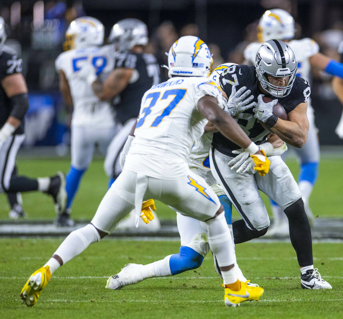 Raiders tight end Michael Mayer (87) battles for more yards after a reception against Los Angel ...