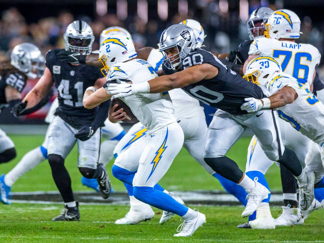 Raiders defensive tackle Jerry Tillery (90) sacks Los Angeles Chargers quarterback Easton Stick ...