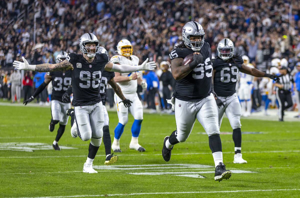 Raiders defensive tackle John Jenkins (95) runs back a Los Angeles Chargers fumble for a touch ...