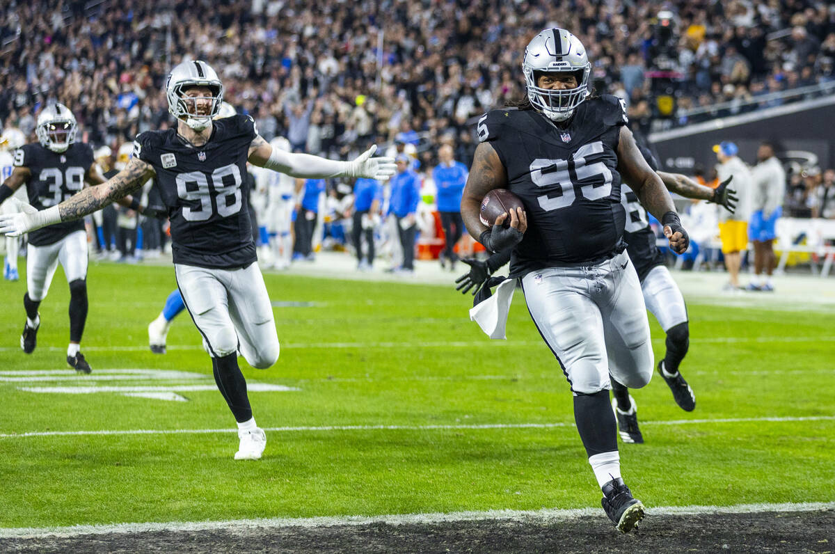 Raiders defensive tackle John Jenkins (95) runs back a Los Angeles Chargers fumble for a touch ...