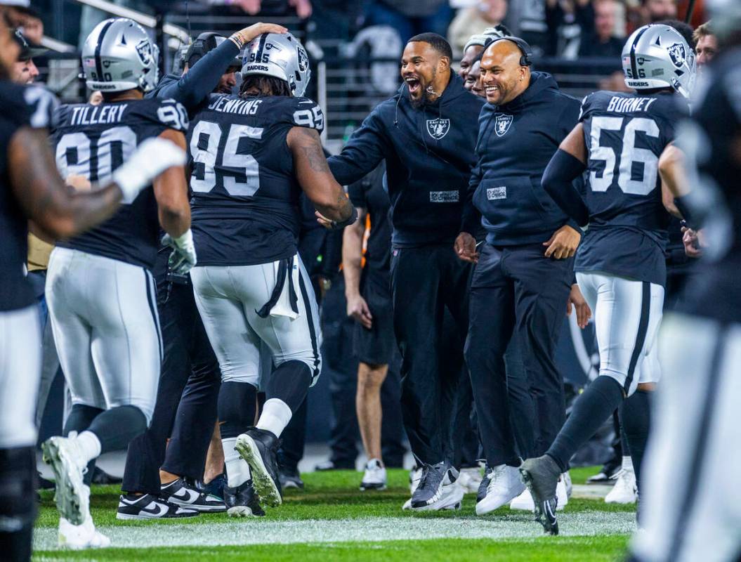 Raiders interim head coach Antonio Pierce and others celebrate a touchdown by defensive tackle ...