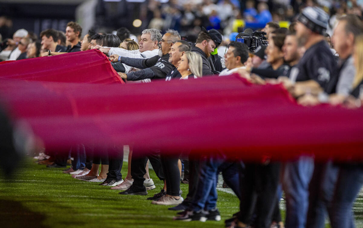 The American flag is waved on the field for the National Anthem before the first half of the Ra ...