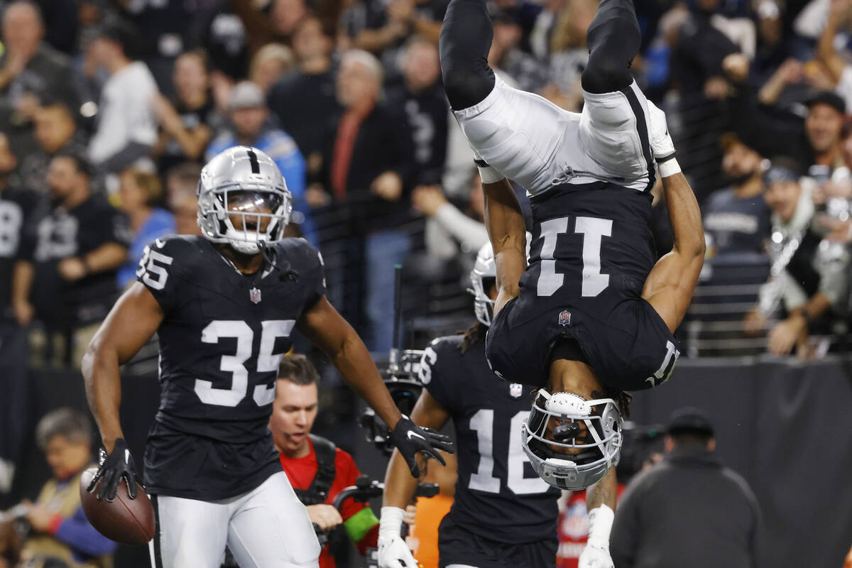 Raiders wide receiver Tre Tucker (11) celebrates his touchdown as running back Zamir White (35) ...